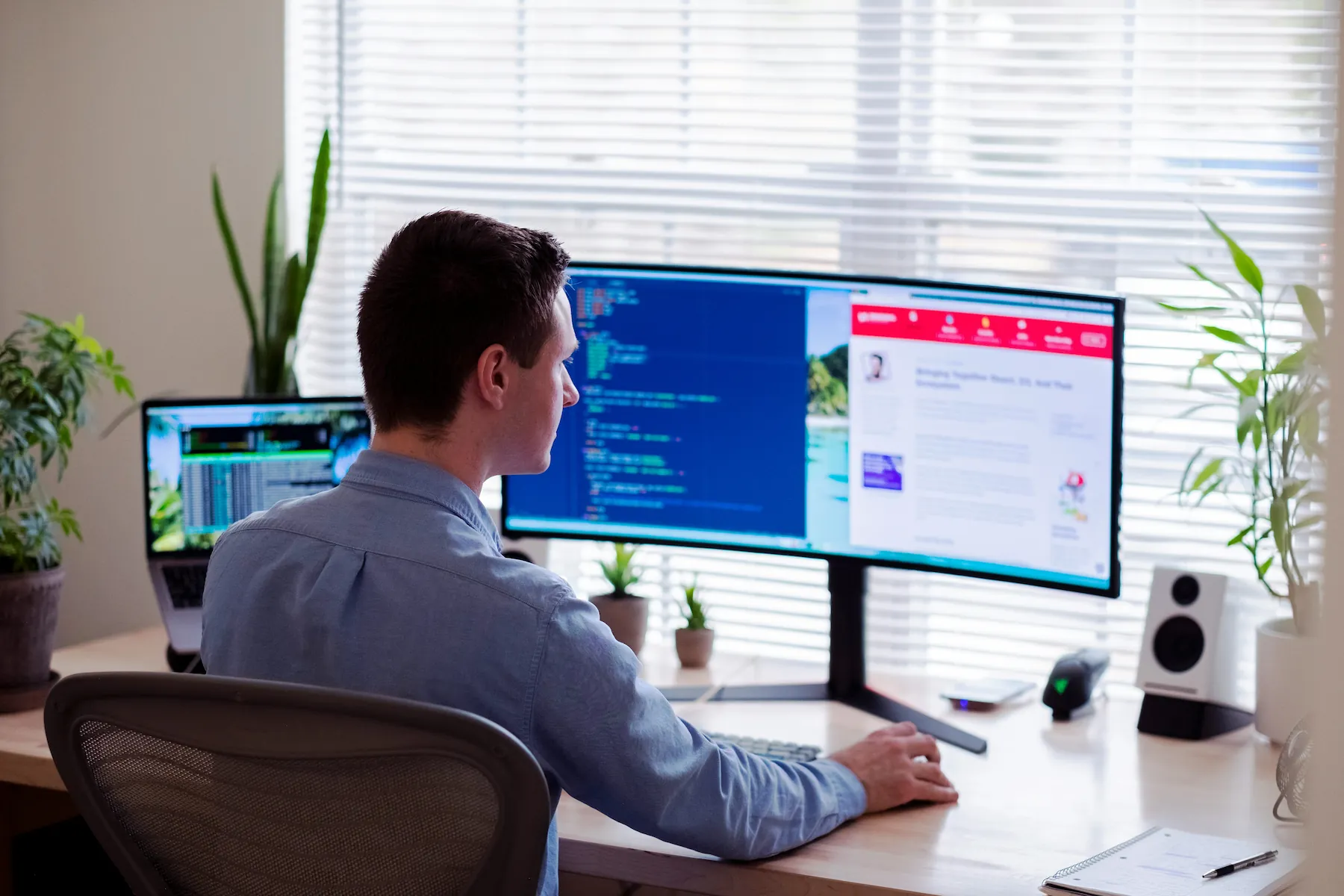 business owners talking around a conference table with their laptops
